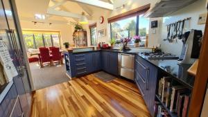 a kitchen with blue cabinets and a counter top at Bay Views on Bay Vista in Pohara