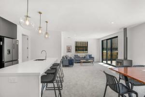 a kitchen and living room with a table and chairs at Vacations on Riverslea in Wanaka