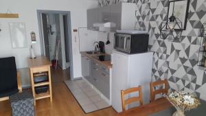 a kitchen with a microwave on top of a refrigerator at Le Sentier des Lavandes in Vresse-sur-Semois