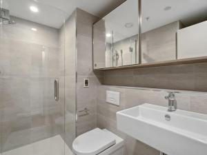 a bathroom with a toilet and a sink and a shower at Shotover Serenity in Queenstown