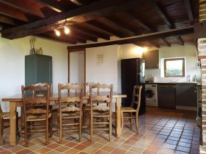 - une cuisine avec une table et des chaises en bois dans la chambre dans l'établissement La maison du Rebours - Gîte à la campagne 6/8 pers, à Haussez
