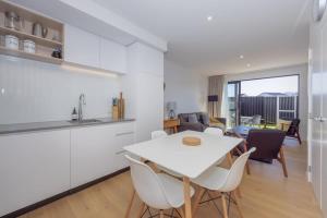 a kitchen and living room with a white table and chairs at Rivers Bank in Albert Town