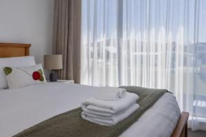 a hotel room with a bed with towels on it at Rivers Bank in Albert Town