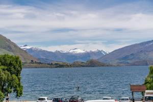 a view of a lake with mountains in the background at Pembroke Luxury Apartment in Wanaka