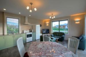 a kitchen and dining room with a table and chairs at Cosy on Kingston in Albert Town