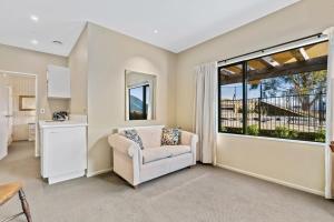 a living room with a couch and a large window at Dublin Downs in Albert Town