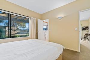 a bedroom with a large bed and a large window at Dublin Downs in Albert Town