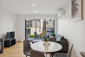 a living room with a table and chairs at Rivers Edge - Alberttown in Albert Town