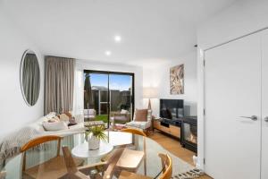 a living room with a couch and a table at Wanaka Riverside Townhouse Retreat in Albert Town
