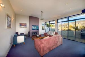 a living room with a couch and a table at Mataraki Magic in Wanaka