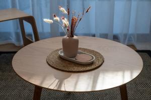 a round table with a vase on top of it at Albert Town Whare in Albert Town