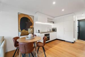 a kitchen and dining room with a table and chairs at Wanaka Hararei in Albert Town