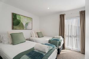 a hotel room with two beds and a window at Wanaka Hararei in Albert Town