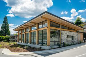 a building with large glass windows on a street at Lakeview Luxury Vista in Wanaka