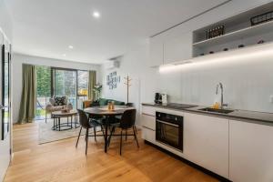 a kitchen and dining room with a table in it at Riverside Terrace in Albert Town