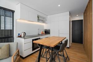 a kitchen and dining room with a wooden table and chairs at Wilbro in Albert Town
