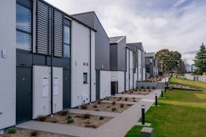 a row of white buildings with plants in a field at Wilbro in Albert Town +6 photos