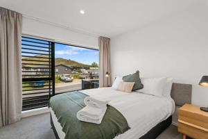 a bedroom with a large bed and a large window at Rivers Abode in Albert Town