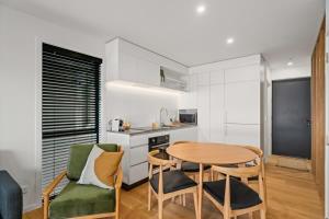 a kitchen and dining room with a table and chairs at Rivers Abode in Albert Town