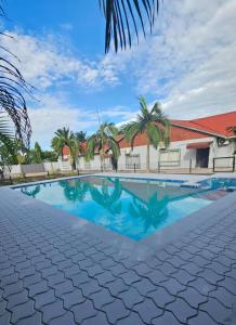a swimming pool in front of a building at Artem Apartments - Apartment 1 in Kitwe
