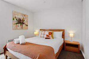 a bedroom with two beds and two lamps in it at Madras Retreat in Christchurch