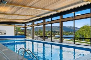 een zwembad met uitzicht op de bergen bij Lakefront Premier Studio in Wanaka
