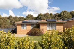 a house with solar panels on the roof at Sharp Road - Comfy & Cosy near Hospital and Cadia in Orange