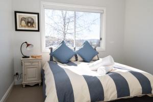 a bedroom with a bed with blue and white pillows at Windera - Escape to the Country Sleeps 10 in Borenore