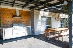 a patio with a stove and a table and a dining table at Windera - Escape to the Country Sleeps 10 in Borenore