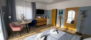 a bedroom with a bed and a table and a tv at Pension Villa Marit in Prague