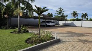 a car parked in a parking lot next to a house at Artem Apartments - Apartment 2 in Kitwe