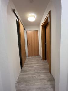 a corridor of a hallway with wooden doors at FeWo HansUndChrista in Mariapfarr