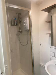 a bathroom with a shower and a sink at Clocktower Apartment in Kent