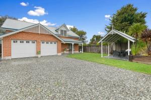 a house with a driveway and a garage at Peel St - Large Family Home Walk to CBD in Bathurst