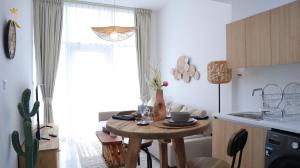 a kitchen with a small table in a room at Ivory Haven - Stylish 1BR Apartment in Oasis, Tranquil Stay Near Masdar Park in Abu Dhabi