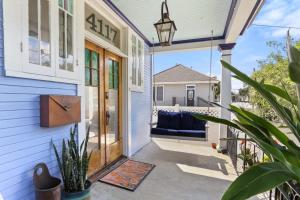 a front door of a house with a couch on the porch at Beautiful Historic Mid City Home in New Orleans