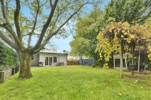 a house with a tree in the yard at Kinross Cottage Close to CBD Comfy & Convenient in Orange