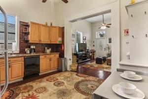 a kitchen with wooden cabinets and a counter top at Art Filled Sanctuary in the Heart Of Mid City in New Orleans