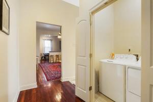 a laundry room with a washer and dryer next to a door at Urban 3 bedroom Local Art Filled Frenchman Oasis in New Orleans +14 photos