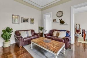a living room with two couches and a coffee table at Edwina Suite II - Fireplace, Elegant Heritage Home in Orange +7 photos