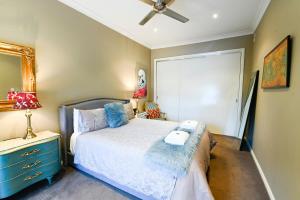 a bedroom with a bed and a blue dresser at Sterling House Spacious Deck BBQ Pet Friendly in Dubbo