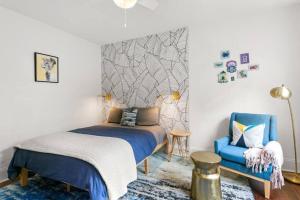 1 dormitorio con 1 cama y 1 silla azul en Garden District Studio Apartment - Gated Parking en Nueva Orleans