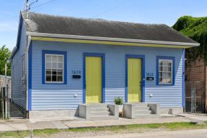 a blue and yellow house with yellow doors at Stylish Creole Cottage 1 BD Home Central Location in New Orleans