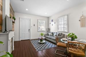 a living room with a couch and a table at Stylish Creole Cottage 1 BD Home Central Location in New Orleans