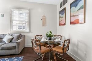 a living room with a table and chairs and a couch at Stylish Creole Cottage 1 BD Home Central Location in New Orleans