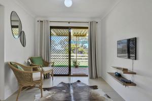 a living room with a chair and a table and a window at Narambla Estate - Rural Retreat, Luxe Hideaway in Orange