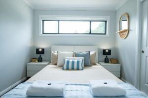 a bedroom with a large bed with two pillows on it at Cosy Retreat on Naman - Private & Convenient in Dubbo