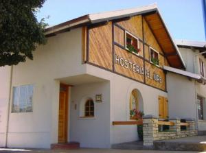 a building with a sign on the front of it at Hosteria El Ñire in San Carlos de Bariloche