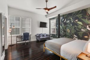 a bedroom with a bed and a desk and a fan at Stylish 2-Bedroom Apartment in Garden District in New Orleans