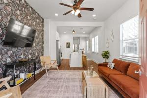 a living room with a couch and a flat screen tv at Fabulous Classy and Comfy 3BD 2BA Home and Parking in New Orleans